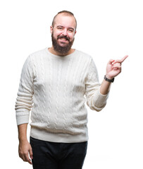 Young caucasian hipster man wearing winter sweater over isolated background with a big smile on face, pointing with hand and finger to the side looking at the camera.
