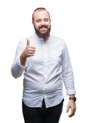 Fototapeta premium Young caucasian hir man over isolated background doing happy thumbs up gesture with hand. Approving expression looking at the camera with showing success.