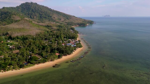 calm beach with crystal clear water on the blue sky at Koh Libong, Trang province Thailand Andaman Sea. Drone aerial view above the beach