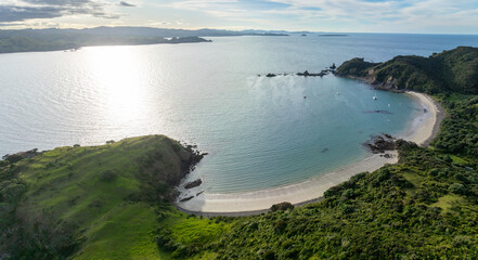 Island off the coast of Matauri Bay at sunset, Northland, New Zealand.