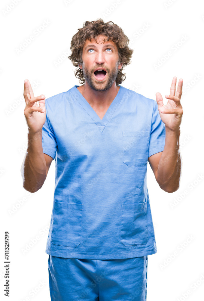 Poster handsome hispanic surgeon doctor man over isolated background crazy and mad shouting and yelling wit