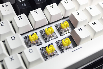 A professional mechanical keyboard with yellow switches used for typing or gaming.