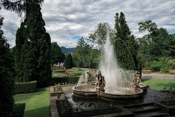 Fountain in the park under a cloudy sky