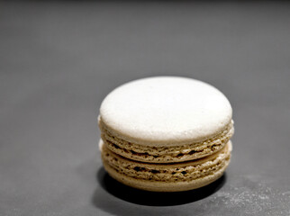 a macaron sitting on a monochrome background