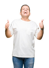 Middle age arab man wearig white t-shirt over isolated background success sign doing positive gesture with hand, thumbs up smiling and happy. Looking at the camera with cheerful expression.