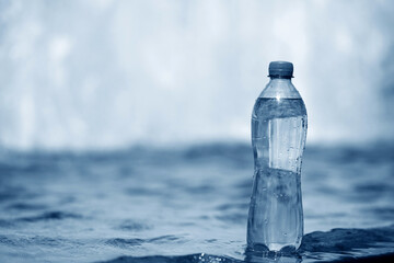 A bottle of pure water on water background