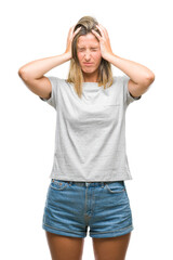 Fototapeta premium Young beautiful woman over isolated background suffering from headache desperate and stressed because pain and migraine. Hands on head.