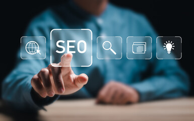Fototapeta na wymiar Businessman touch virtual SEO icons to analyze SEO search engine optimization for promoting ranking traffic on website and optimizing your website to rank in search engines.
