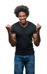 Afro american man over isolated background celebrating surprised and amazed for success with arms raised and open eyes. Winner concept.