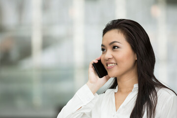 Asian business woman using smartphone.