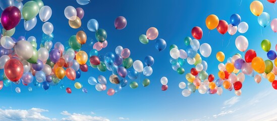 hundreds of colorful balloons in the air against a blue sky background