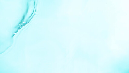 Close-up of splashing water surface on light blue background