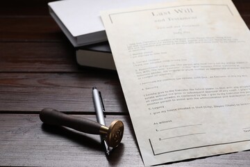 Last Will and Testament, stamp seal, books and pen on wooden table