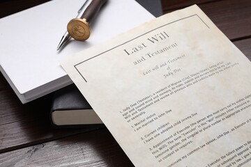 Last Will and Testament, books, stamp seal and pen on wooden table, closeup