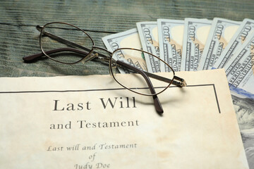 Last Will and Testament, glasses and dollar bills on rustic wooden table, closeup