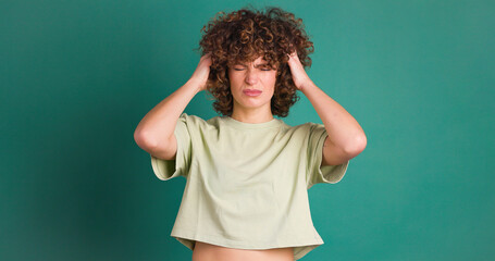 Fototapeta premium Adult woman with her hands on her head because of a confusion