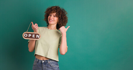 woman with closed sign on green background