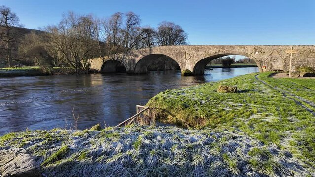 Historic ancient bridge over The River Suir at Kilsheelan Village Tipperary on a bright winter morning