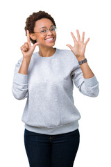 Young beautiful african american woman wearing glasses over isolated background showing and pointing up with fingers number seven while smiling confident and happy.