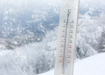 Thermometer showing temperature below zero outdoors on winter day