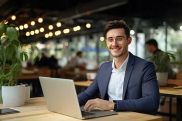Happy Young Professional Sitting in a Modern Office, Using Laptop - Banner of Successful Entrepreneurship, Corporate Success, and Wireless Connectivity, Confident Businessman at Work