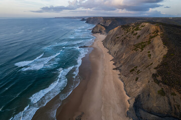 Cordoama beach in Portugal. Aerial drone view of waves, sandy beach and cliffs