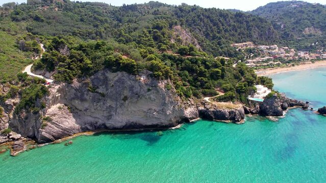 Greece summer holidays. Best beaches of Corfu island. Glyfada beach and village, aerial drone view  in western part.