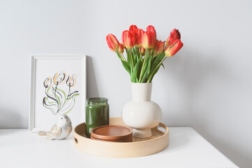 spring home decoration with flowers, bouquet of red tulips with handmade aquarelle poster on white background