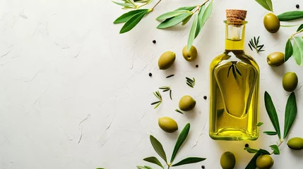 Fotobehang Extra Virgin Olive Oil in a Glass Bottle with Fresh Olives and Green Leaves on a Textured Background. © Juan