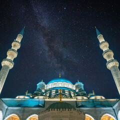Islamic or ramadan concept image. Eminonu New Mosque with milky way.