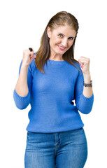 Beautiful middle age mature woman wearing winter sweater over isolated background looking confident with smile on face, pointing oneself with fingers proud and happy.