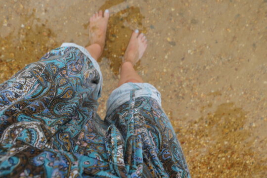 feet on sand in water
