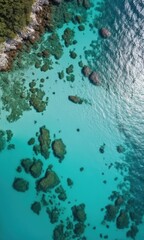 Fototapeta na wymiar Aerial View of Clear Turquoise Water and Rocky Shoreline