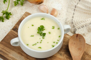 Bowl of cream soup on white table	