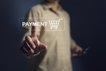Payment concept with hand touch on payment button and shopping cart to pay money for online...