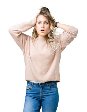 Beautiful young blonde woman wearing sweatershirt over isolated background Crazy and scared with hands on head, afraid and surprised of shock with open mouth