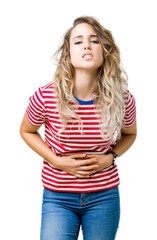 Fototapeta premium Beautiful young blonde woman over isolated background with hand on stomach because indigestion, painful illness feeling unwell. Ache concept.