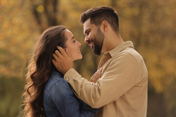 Beautiful couple spending time together in autumn park