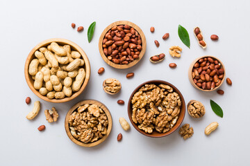 Walnut kernel halves, in a wooden bowl. Close-up, from above on colored background. Healthy eating Walnut concept. Super foods with copy space
