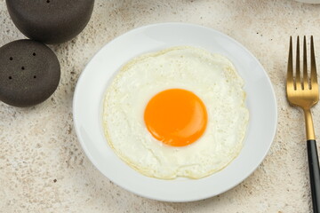 sunny side up fried egg on white table