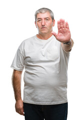 Handsome senior man over isolated background doing stop sing with palm of the hand. Warning...
