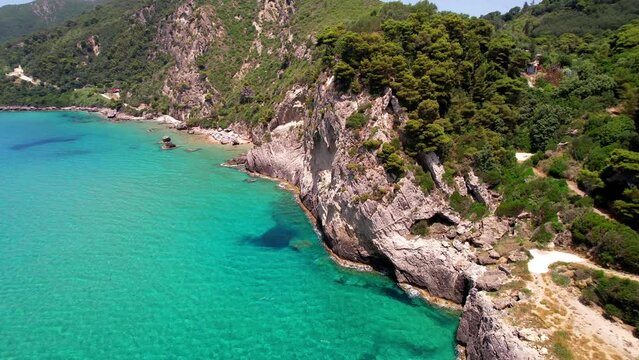 Greece summer holidays. Best beaches of Corfu island. Glyfada beach and village, aerial drone view  in western part.