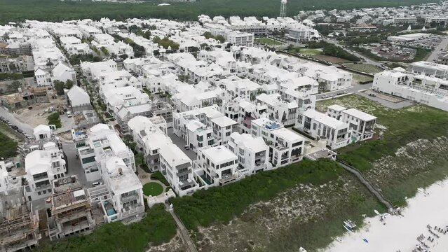 turning to right motion town of Arys beach with lots of white houses and buildings with some under construction