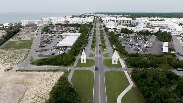 view going west of East entrance of Alys beach town with active transit with seaside on left and land and wood side on the right
