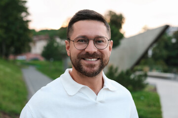 Fototapeta premium Portrait of handsome bearded man in glasses outdoors