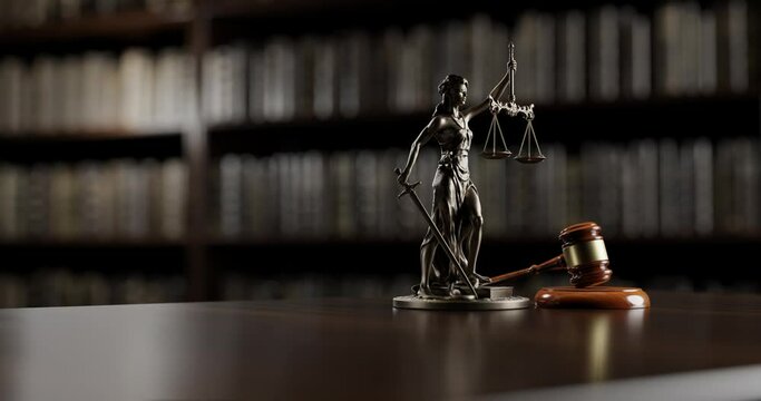 Legal Concept: Themis is the goddess of justice and the judge's gavel hammer as a symbol of law and order on the background of books