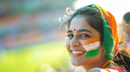 Happy Indian woman supporter with face painted in India flag colors, green white and orange, female...