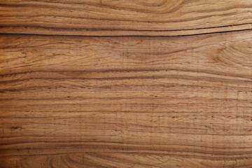 Textura de uma tábua de madeira, com veios e vincos de cor bege e marrom.