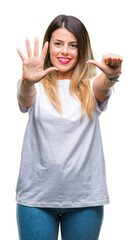 Young beautiful woman casual white t-shirt over isolated background showing and pointing up with fingers number six while smiling confident and happy.