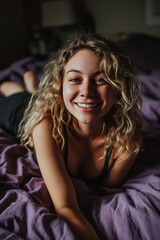 Fototapeta premium blond girl with curly hair in bed